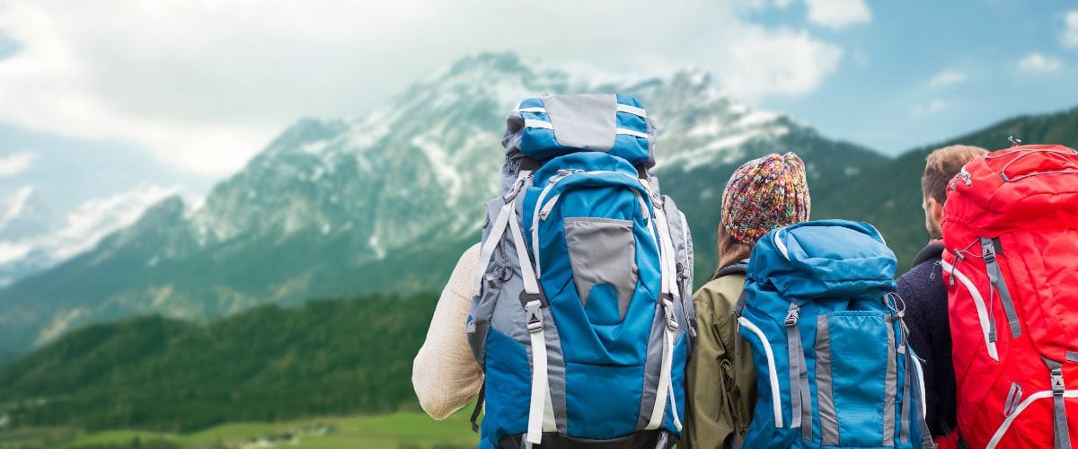 3 Hikers With Backpacks Looking At The Distant Mountains - Looking For Ideas for Adventure